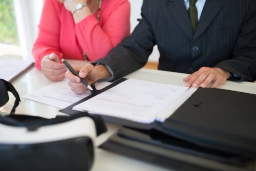 couple drafting document with lawyer