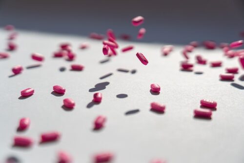 pink pills falling to ground