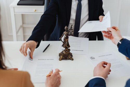 couple and lawyer signing divorce papers