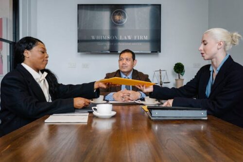 three lawyers sitting at a table