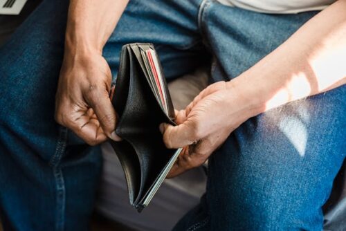 person holding empty wallet
