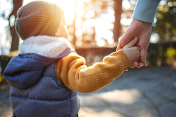 child holding hand of parent