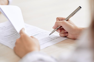 woman signing postnuptial agreement