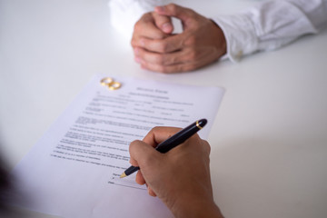 person signing a prenuptial agreement