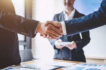 shaking hands at desk