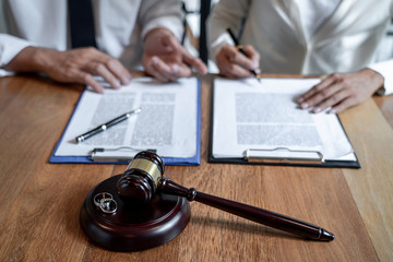 gavel, wedding rings, and separation agreements on clipboards