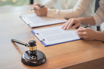 people signing prenuptial agreement
