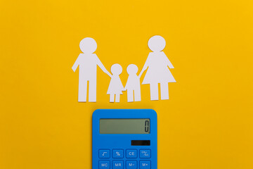 paper cut outs of family and calculator