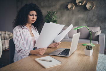woman staring at paper confused