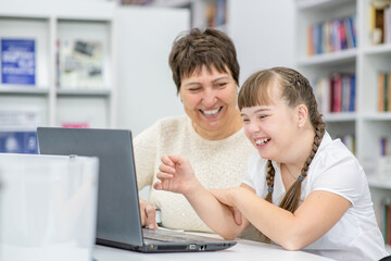 woman and child with special needs on computer