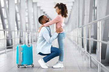 dad hugging daughter at airport