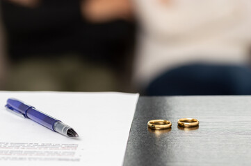 prenuptial contract next to wedding rings