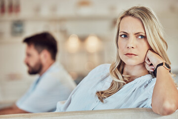 woman staring off into distance with man in background