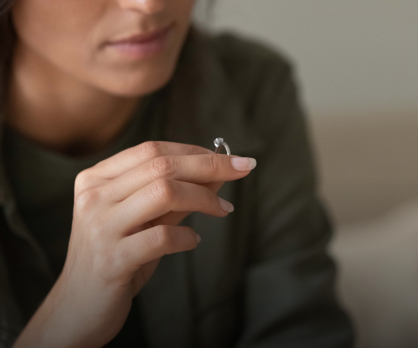 woman taking a wedding ring off