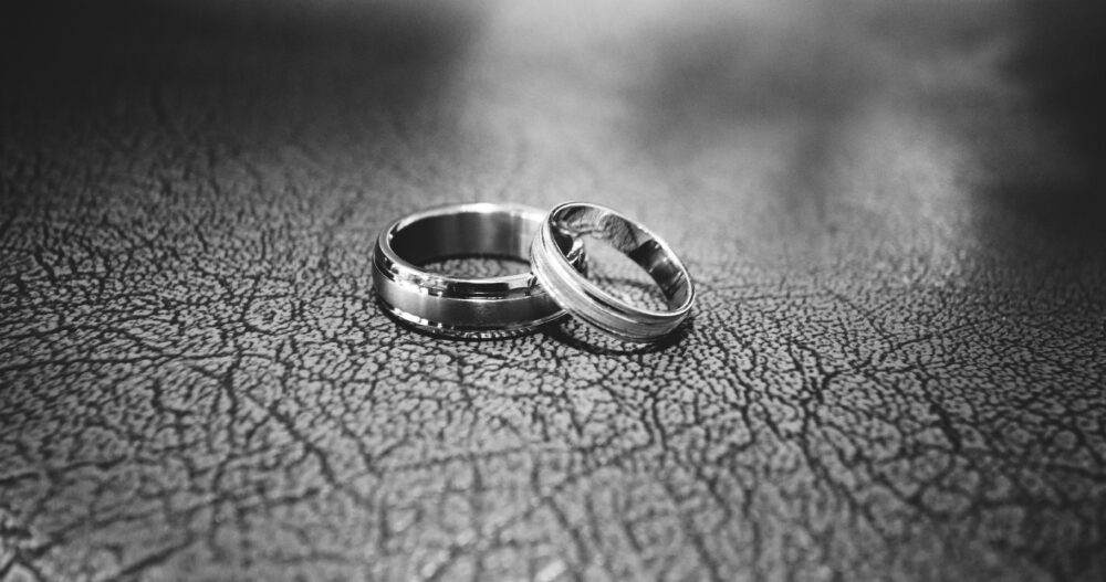 close up of wedding rings on floor 17834 e1665601597938
