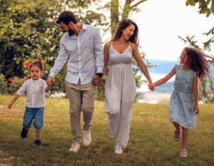 family holding hands outside