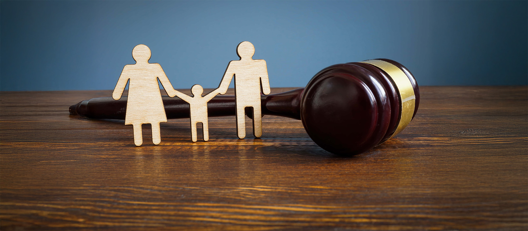 gavel with wooden family figurines