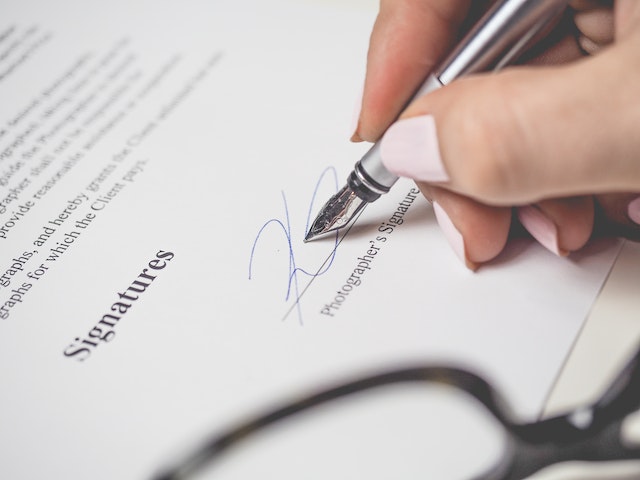 hand signing paper