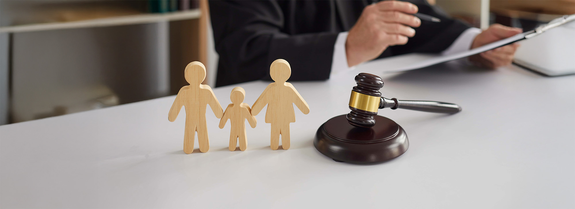 wooden family blocks on desk with gavel and judge