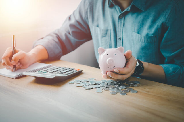 person holding piggy bank retirement