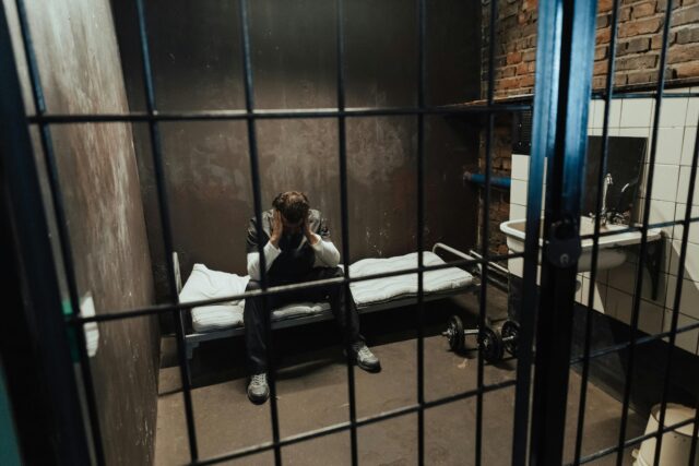 man in prison cell
